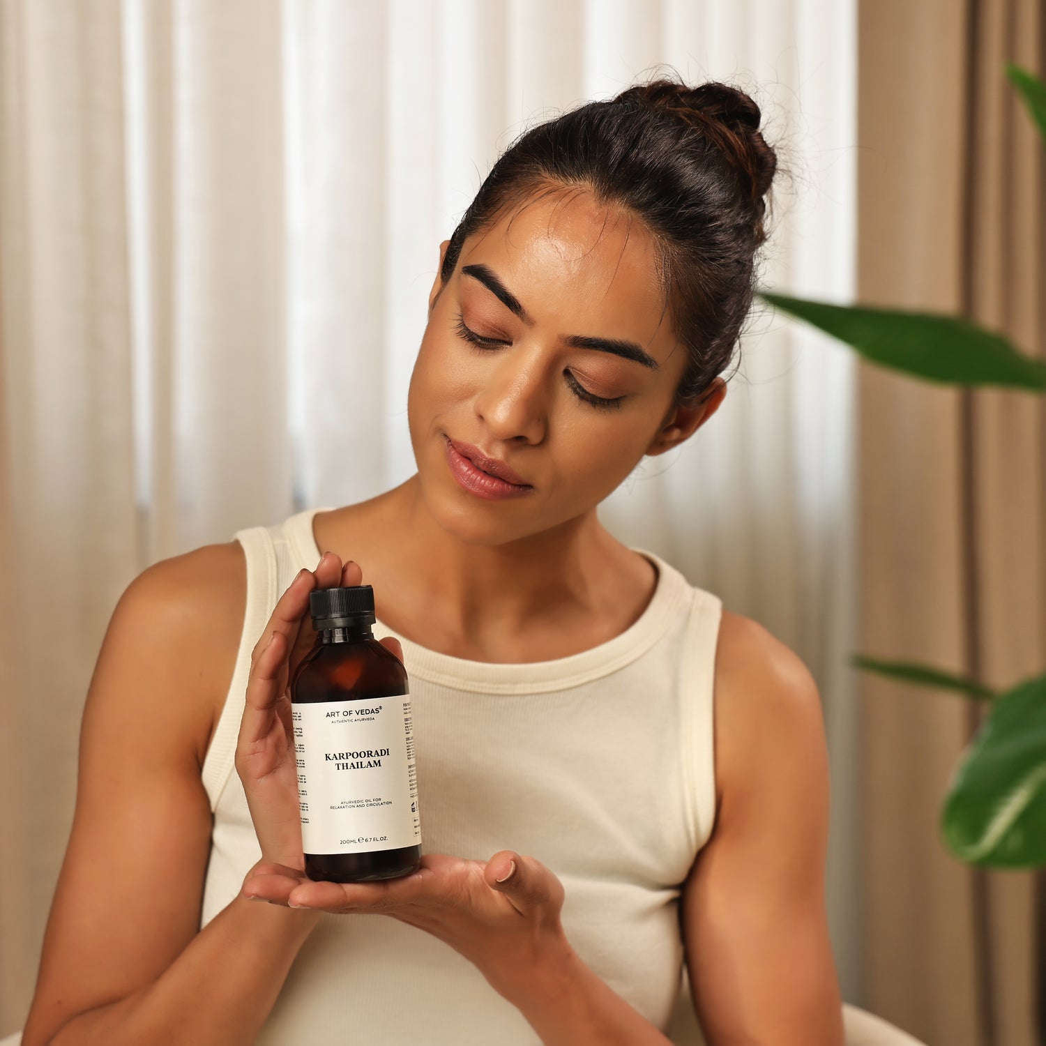 Art of Vedas Thailam Collection artofvedas.com - Woman Holding Authentic Ayurvedic Herbal Oil for Natural Healing
