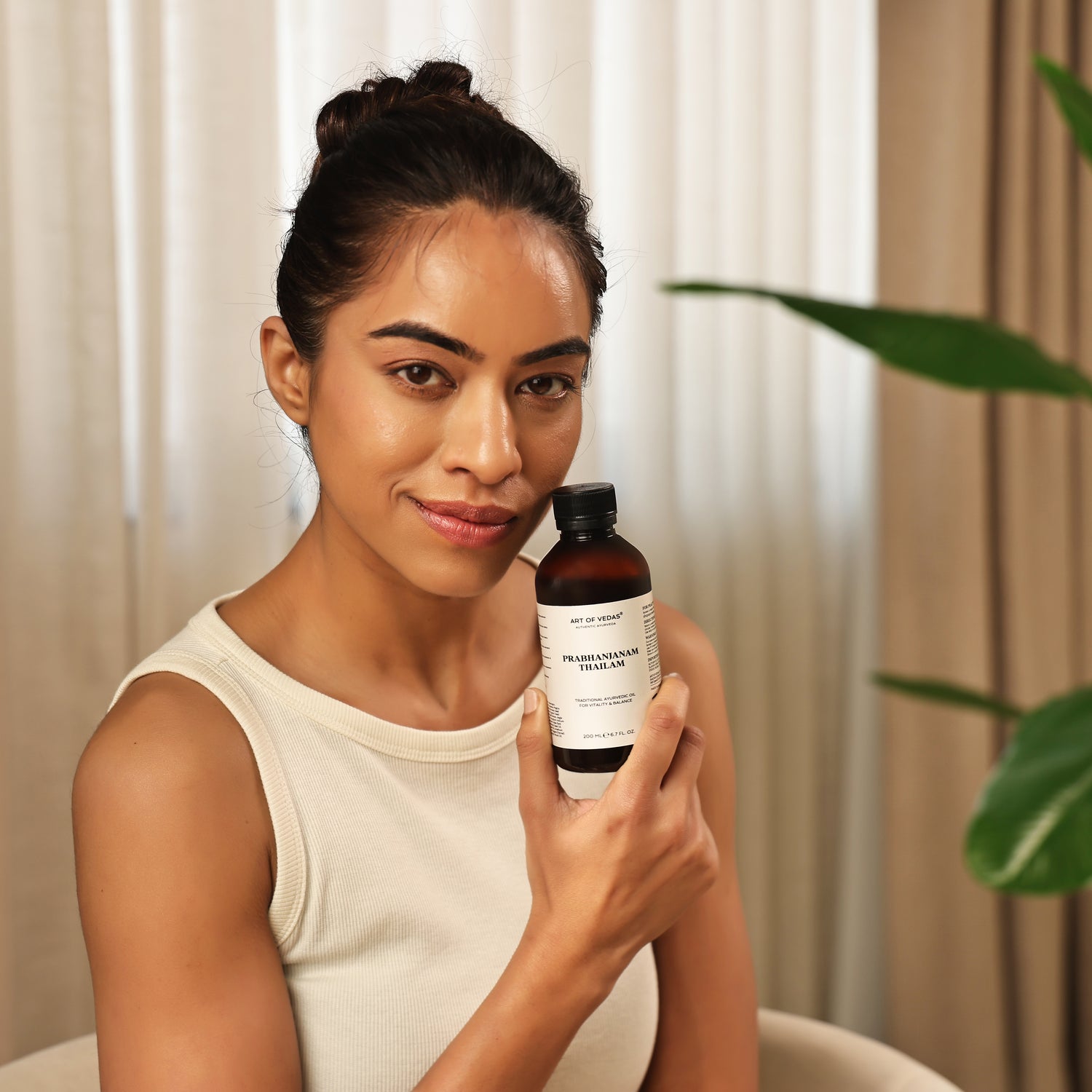 Art of Vedas Prabhanjanam Thailam - Woman Holding Ayurvedic Oil for Vata Disorders and Neuromuscular Support